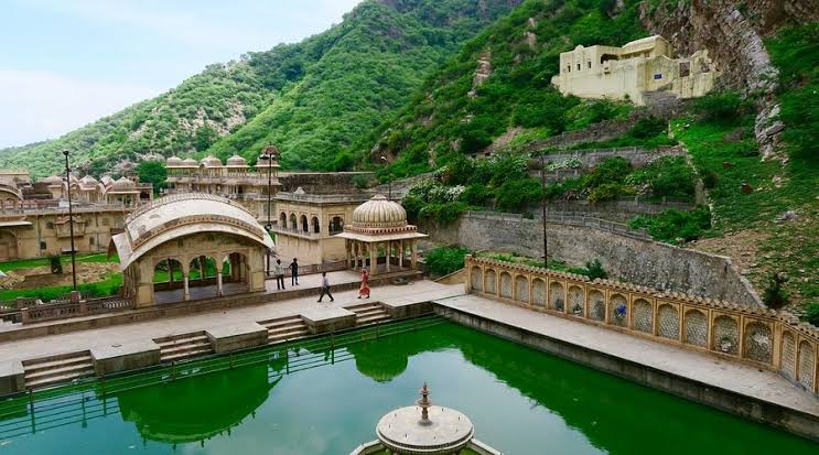 Monkey Temple Jaipur with historic architecture, sacred water tanks, scenic hills, and monkeys roaming around the peaceful Galta Ji complex.