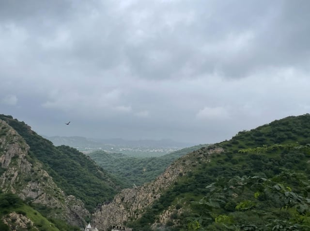 Shan Valley Jaipur with lush green hills and trails.