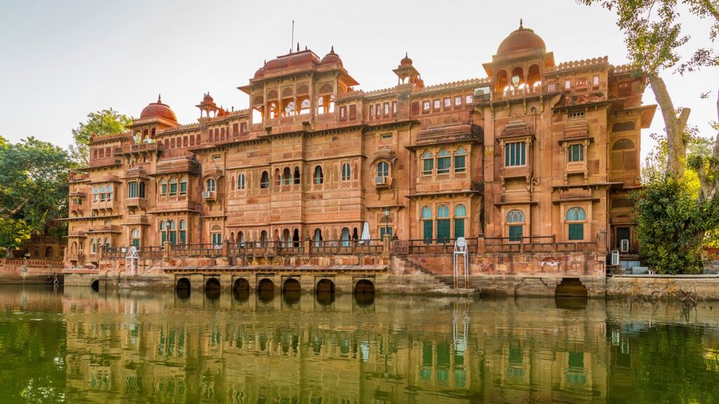 Gajner Palace and Lake in Bikaner showcasing royal architecture, calm waters, lush greenery, and peaceful surroundings, offering a perfect blend of heritage beauty and nature.